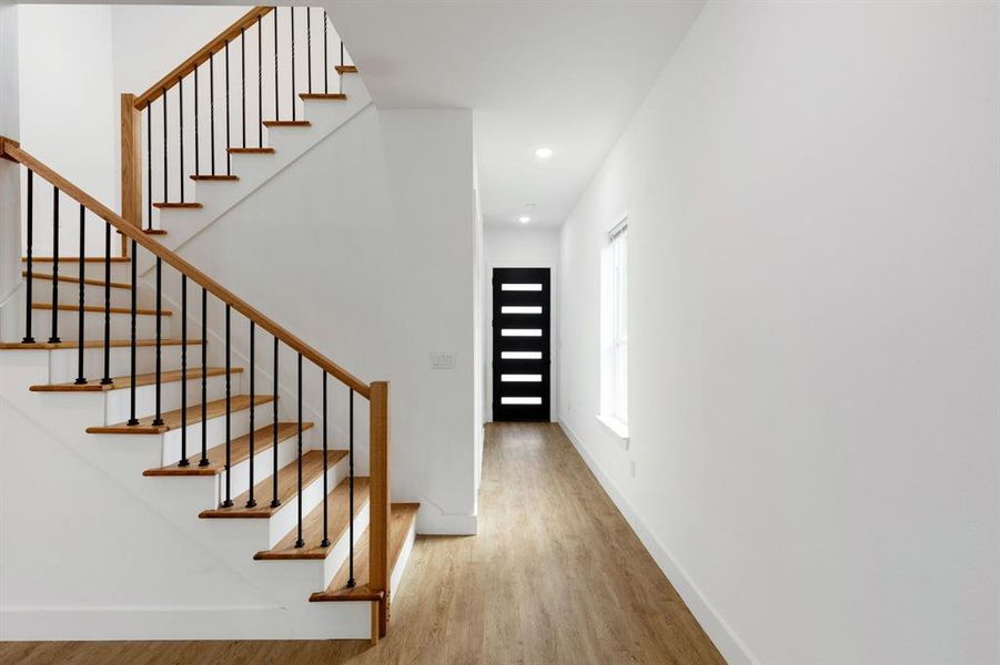 Stairs featuring hardwood / wood-style flooring