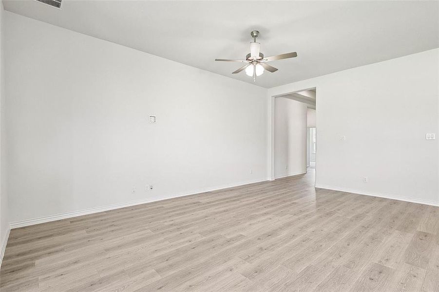 Spare room featuring light wood-type flooring and ceiling fan