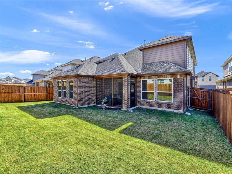 Rear view of house with a lawn