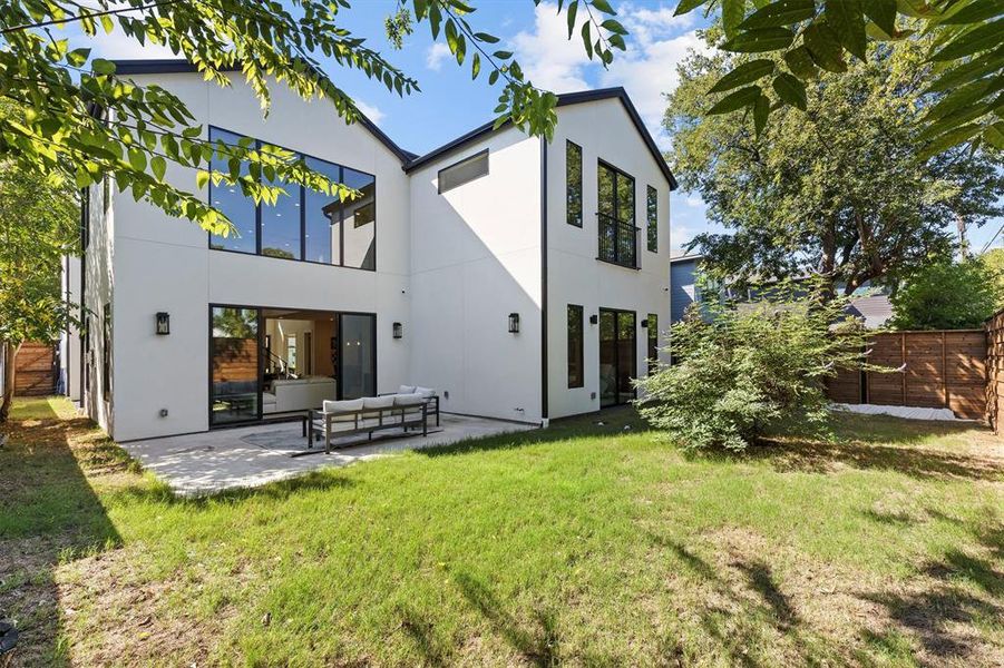 Back of house featuring an outdoor hangout area, a lawn, and a patio