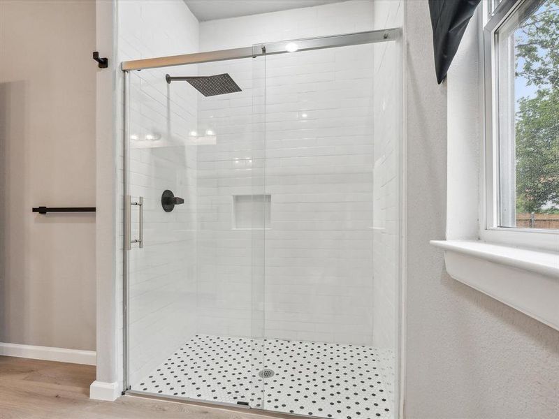 Bathroom featuring wood-type flooring and walk in shower