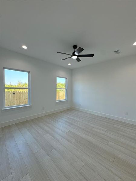 Spare room with light hardwood / wood-style flooring and ceiling fan