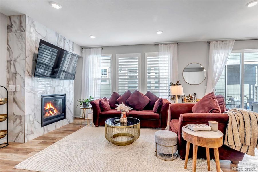 Living room with gas fireplace and marble surround floor to ceiling