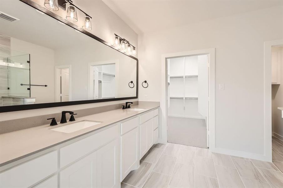 Bathroom with vanity, plus walk in shower, and tile patterned flooring