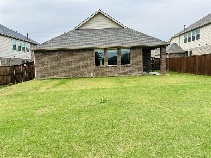 Rear view of house with a lawn