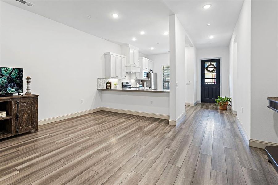 Unfurnished living room featuring light wood-type flooring