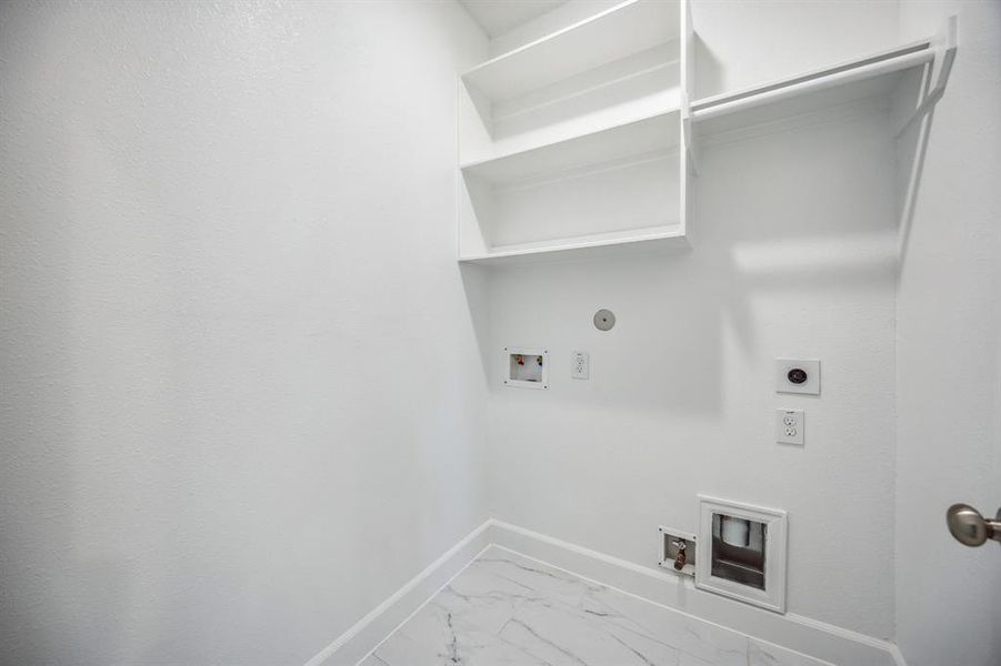 The Utility Room on the second floor provides metropolitan utility at its best, with custom shelves for sleek organization.