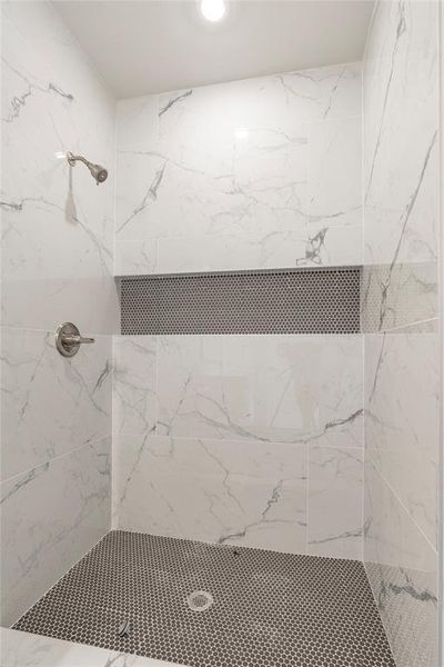 Bathroom featuring tiled shower