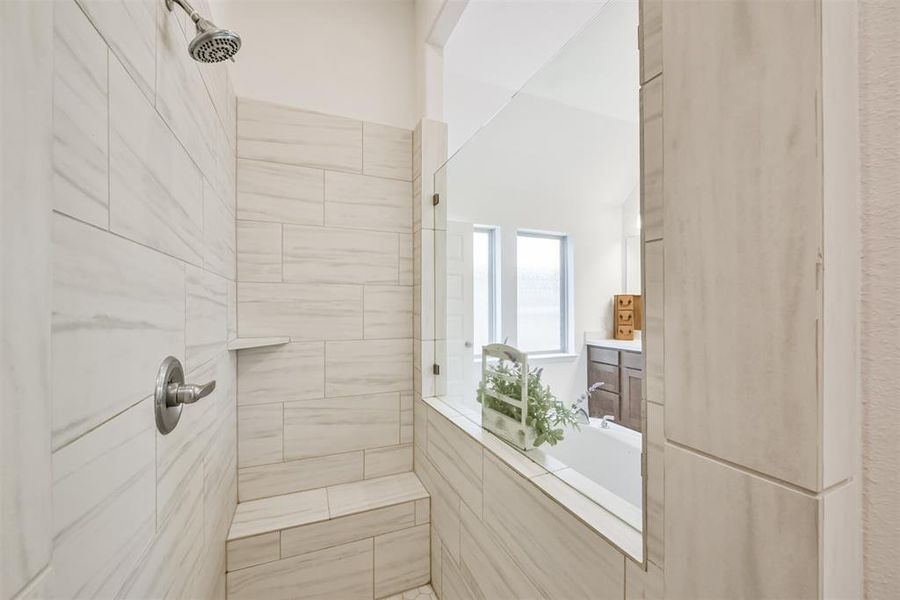 The primary bathroom also has a walk-in shower with tile surround