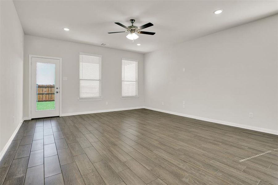 Empty room featuring hardwood / wood-style flooring and ceiling fan
