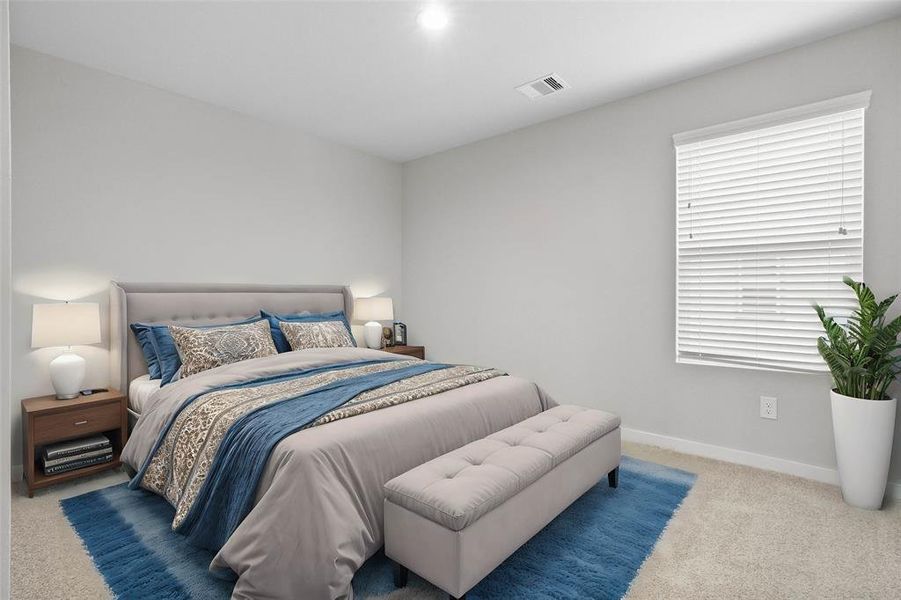 This secondary bedroom features high ceilings, recessed lighting, custom paint, plush carpet, ample closet space, and large windows with privacy blinds!