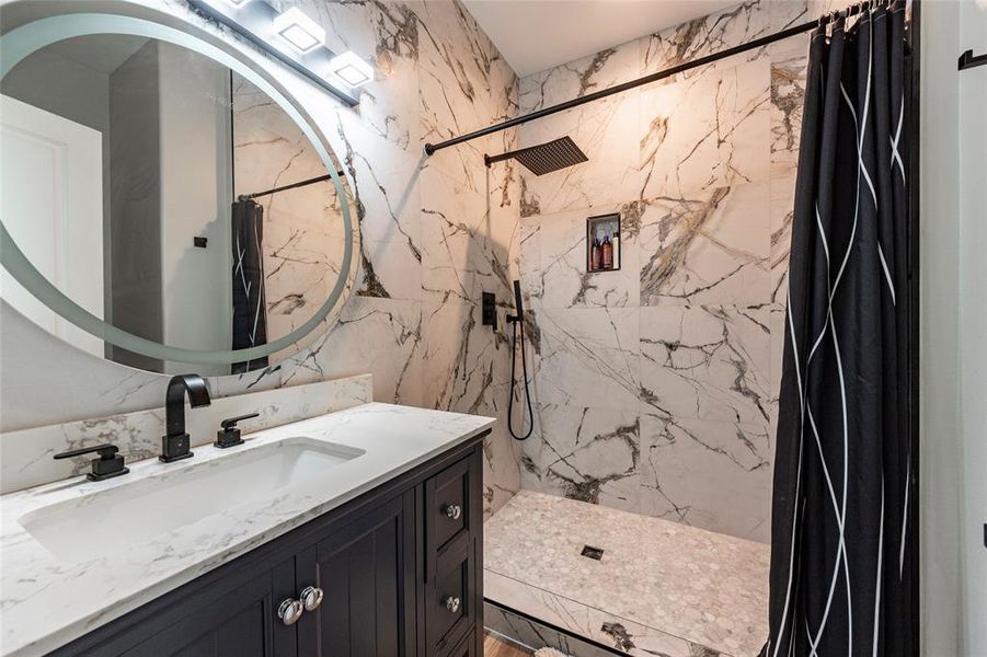 All three full baths are adorned with luxurious marble tile walk-in showers and dual vanities featuring LED lighting. Experience spa-like relaxation and elegance in every bathroom!