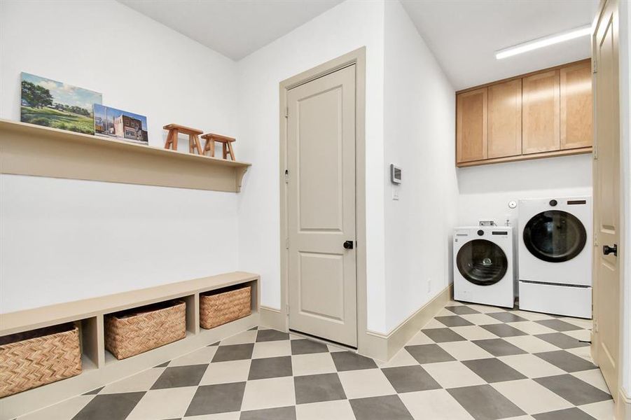 This angle of the laundry/mudroom highlights the additional storage with built-in bench and cubbies for added organization and convenience.