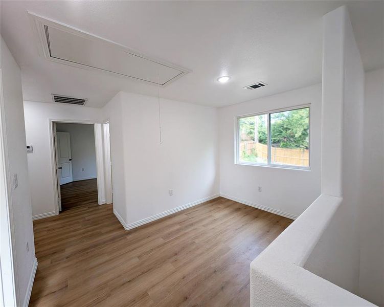 Spare room featuring hardwood / wood-style flooring