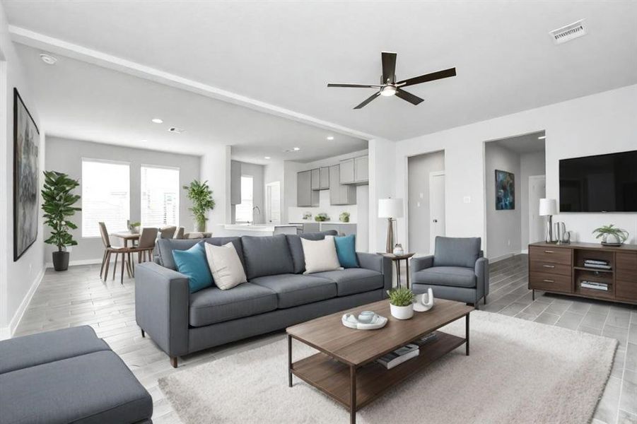 Relax and unwind in this inviting family room, illuminated by abundant natural light streaming in through tall windows, complemented by high ceilings and stunning flooring.