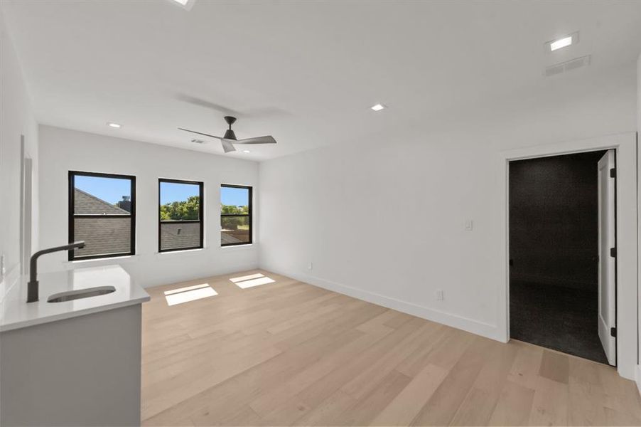 Game Room featuring light wood-type flooring, ceiling fan, and sink