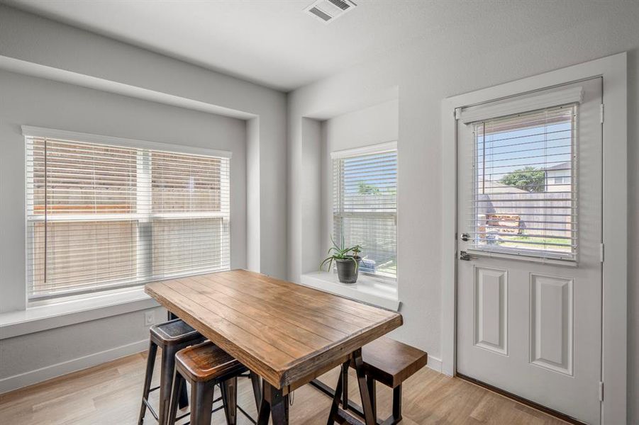 Make memories gathered around the table with your family and friends! This dining area features a window seat, wood like flooring, access to the back patio, and plenty of bright natural light!