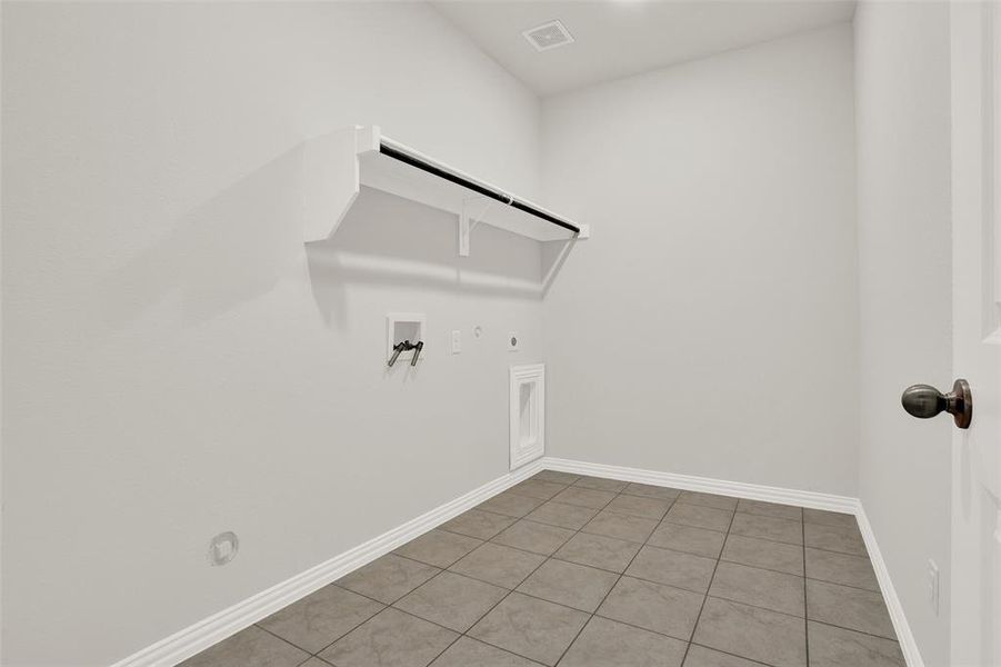 Laundry room with gas dryer hookup, washer hookup, electric dryer hookup, and tile floors