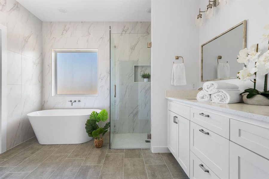 Bathroom with vanity, independent shower and bath, and tile walls