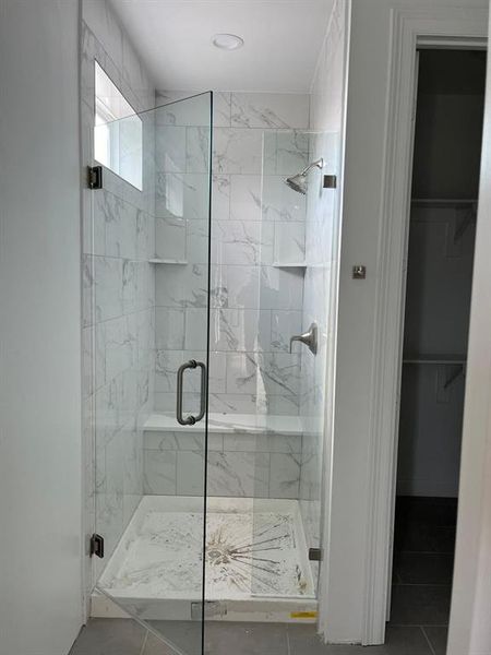 Bathroom with tile floors and a shower with door