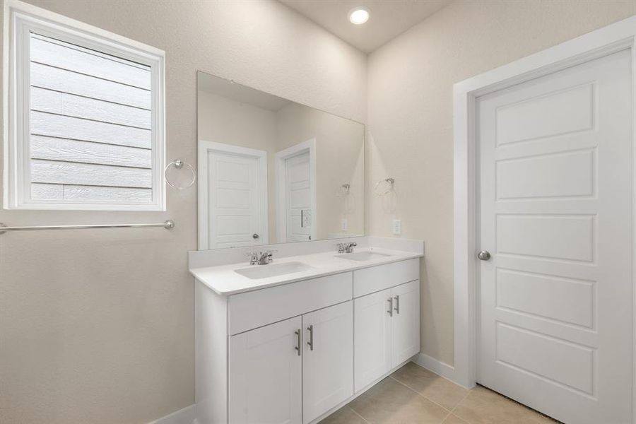 This primary bathroom is definitely move-in ready! Featuring a spa like walk-in shower with tile surround, bright cotton white stained with Quartz countertops, spacious walk-in closet with shelving, high ceilings, neutral paint, sleek and modern finishes.