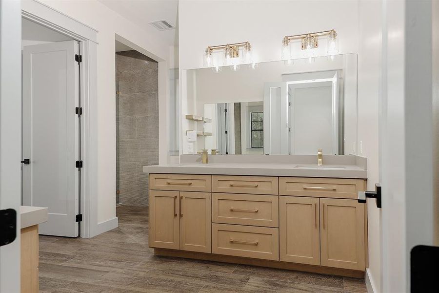 Primary ensuite bathroom with dual vanities