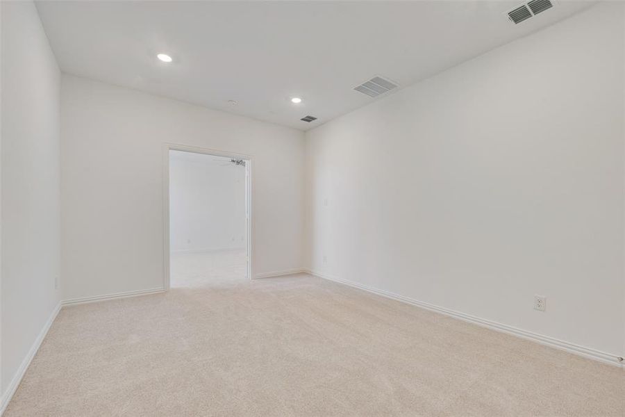 Unfurnished room featuring light colored carpet