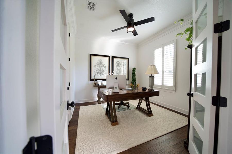 Office area with ceiling fan, french doors, dark hardwood / wood-style floors, and ornamental molding