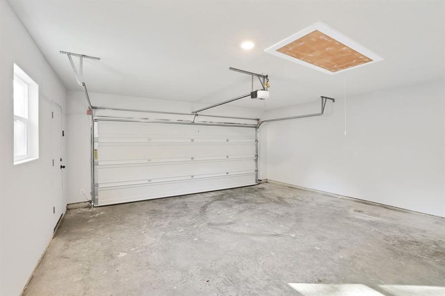 Garage featuring a garage door opener