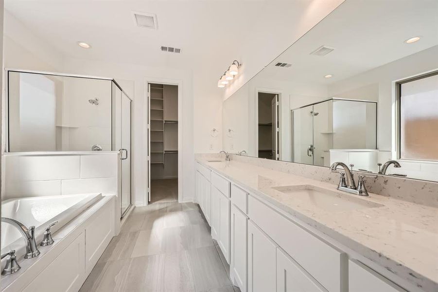 Bathroom featuring vanity and plus walk in shower