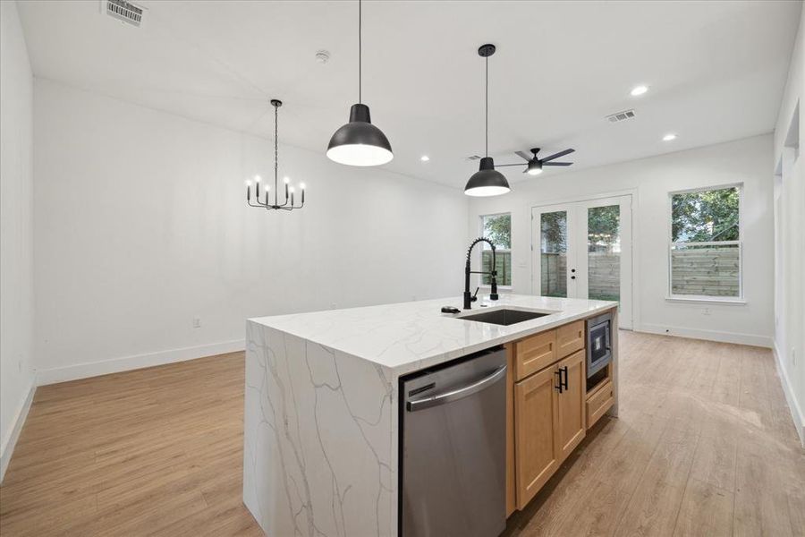 The kitchen features a large islandwith breakfast bar and pendant lighting.