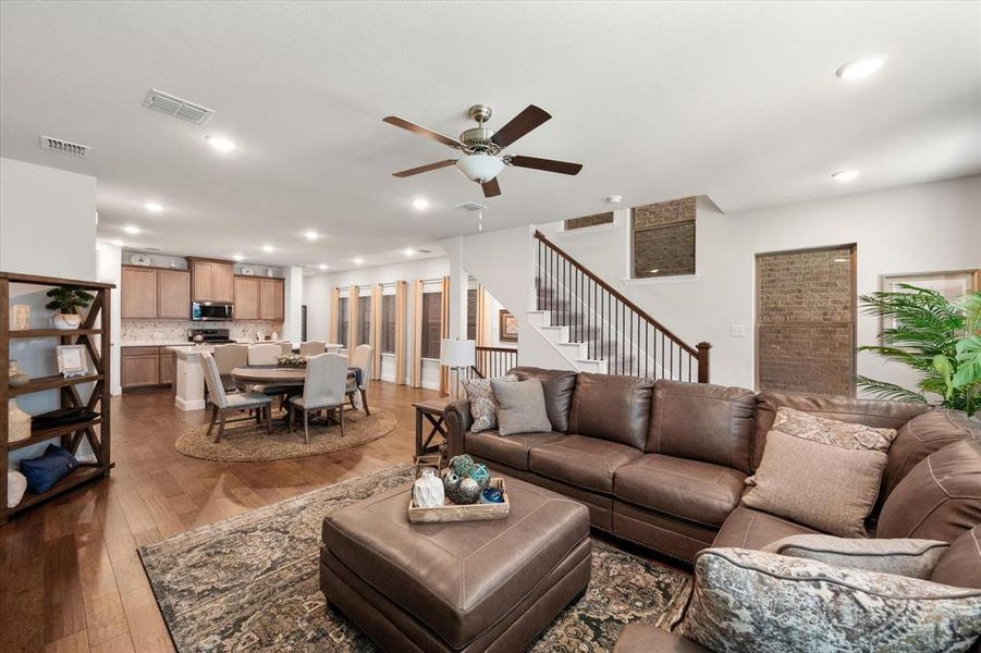 Living room featuring ceiling fan and light hardwood / wood-style flooring