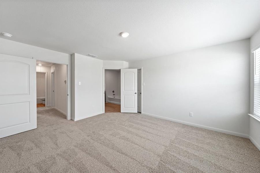 Bedroom featuring light colored carpet