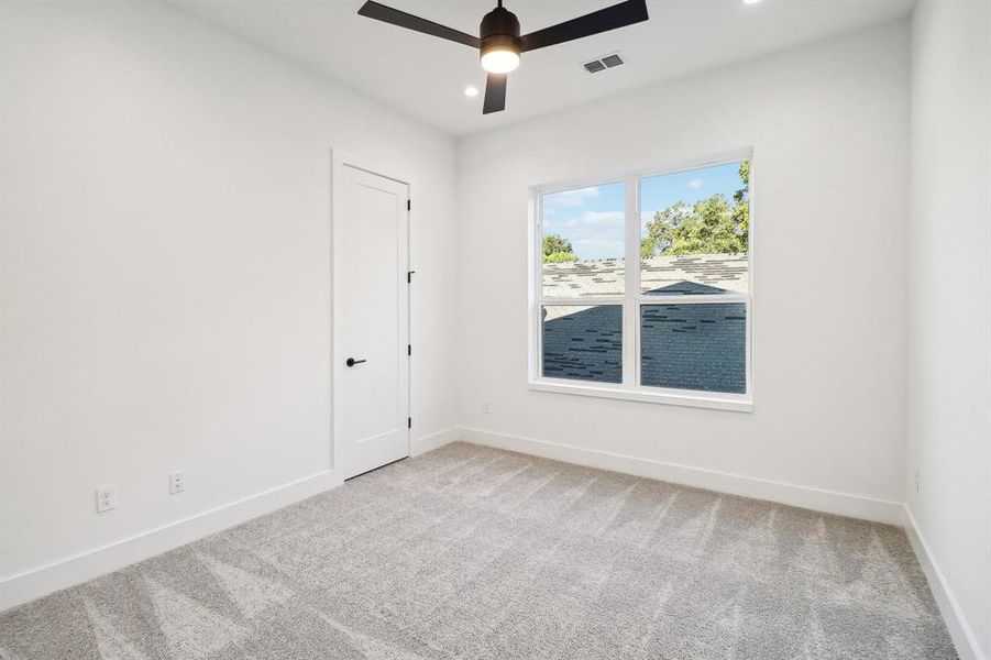 Spare room featuring carpet floors and ceiling fan