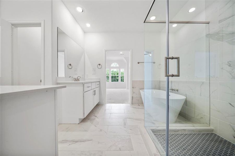 Step into the spa-like Primary Bath! The space features two vanities, custom cabinets, and stunning quartz countertops. (Sample photos of a completed Gibraltar floor plan. The image may feature alternative selections and/or upgrades.)