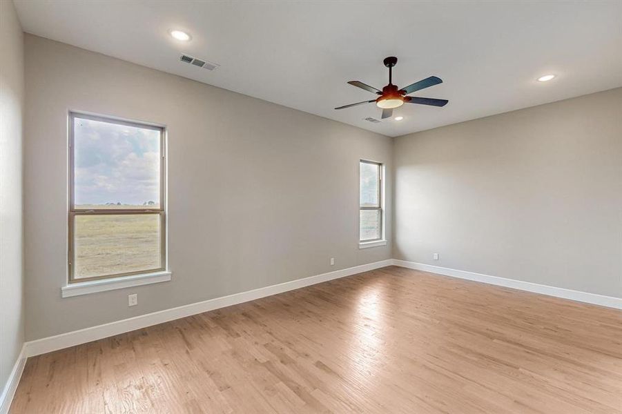 Spare room with light wood-type flooring and ceiling fan