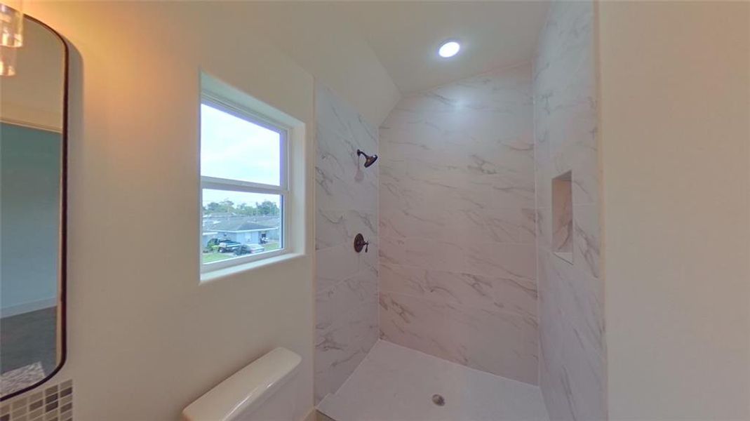 4209 Tampico St. Elegant master shower with porcelain tile from floor to ceiling.