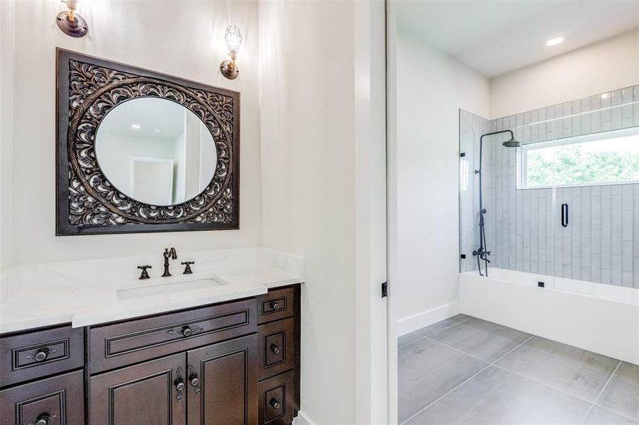 Jack and Jill Bathroom featuring vanity and tile patterned floors