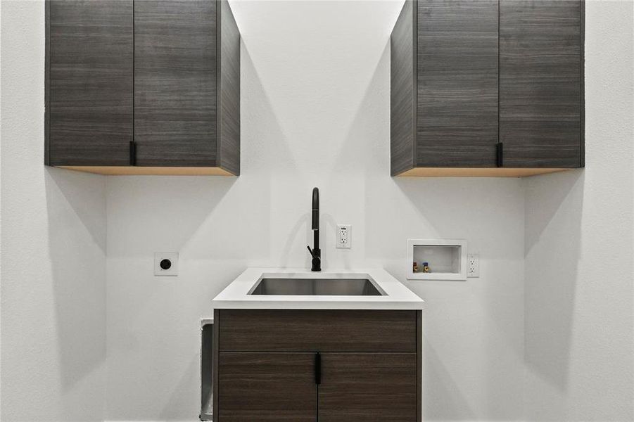 Laundry room featuring hookup for a washing machine, cabinets, sink, and hookup for an electric dryer