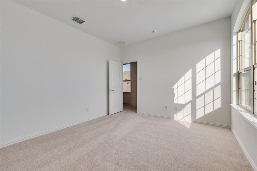 Empty room featuring light colored carpet