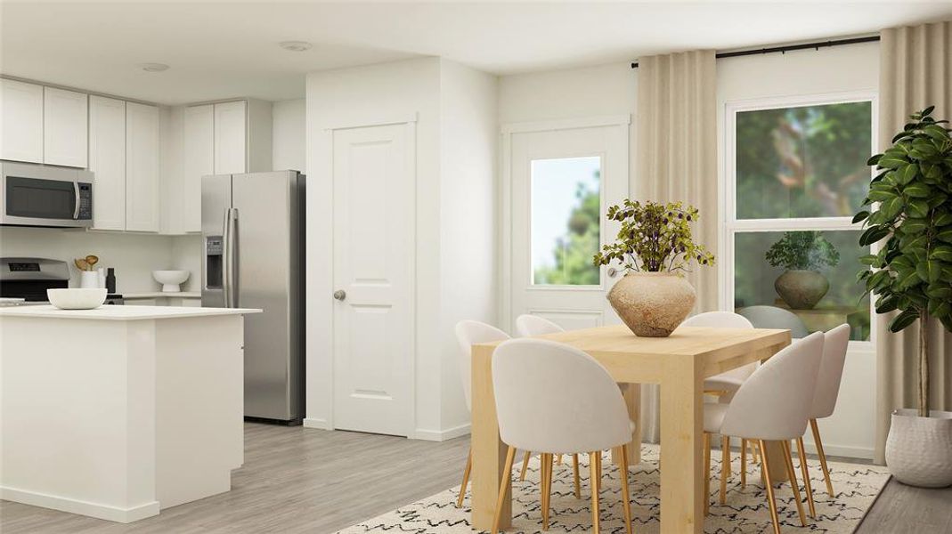 Kitchen featuring light hardwood / wood-style flooring, stainless steel appliances, and white cabinetry