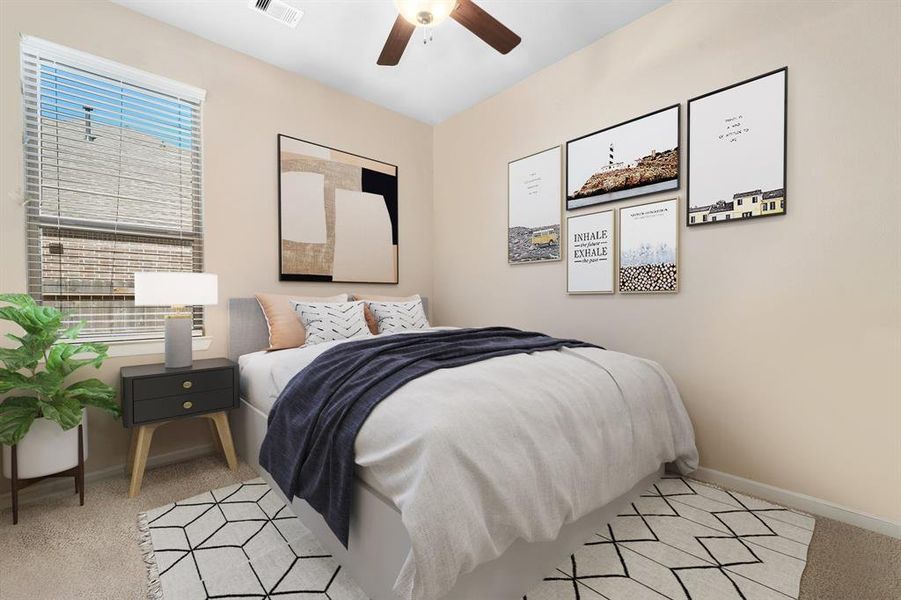 Secondary bedroom features plush carpet, neutral paint, dark stained ceiling fan with lighting and a large window with privacy blinds.