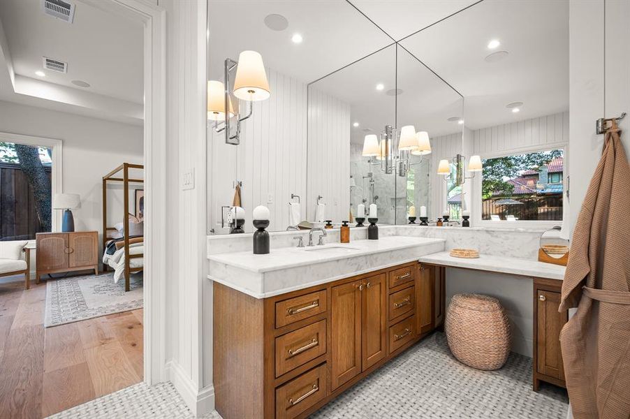 Bathroom with vanity, tasteful backsplash, wood-type flooring, a shower with shower door, and a chandelier