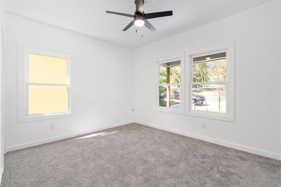 Unfurnished room featuring carpet and ceiling fan