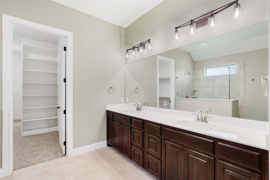 Bathroom with tile patterned floors and dual bowl vanity