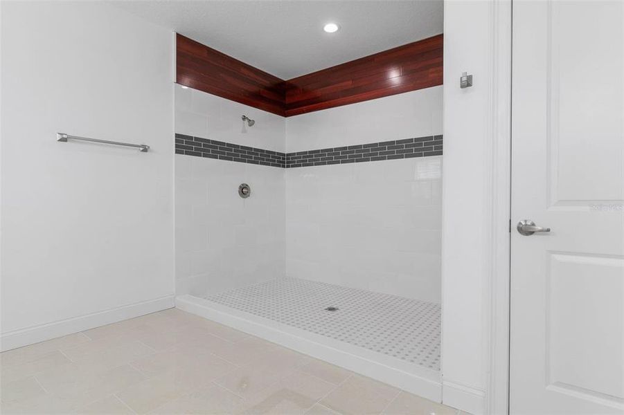 Primary Ensuite Shower is Massive with Tile and Wood accents.