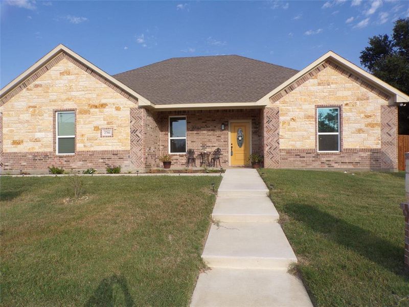 View of front of property with a front yard