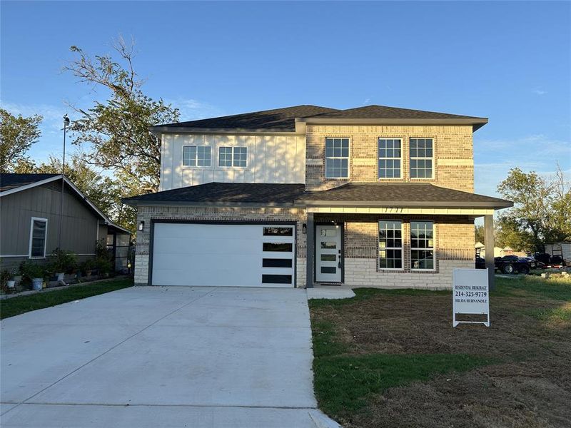 View of front of property featuring a garage