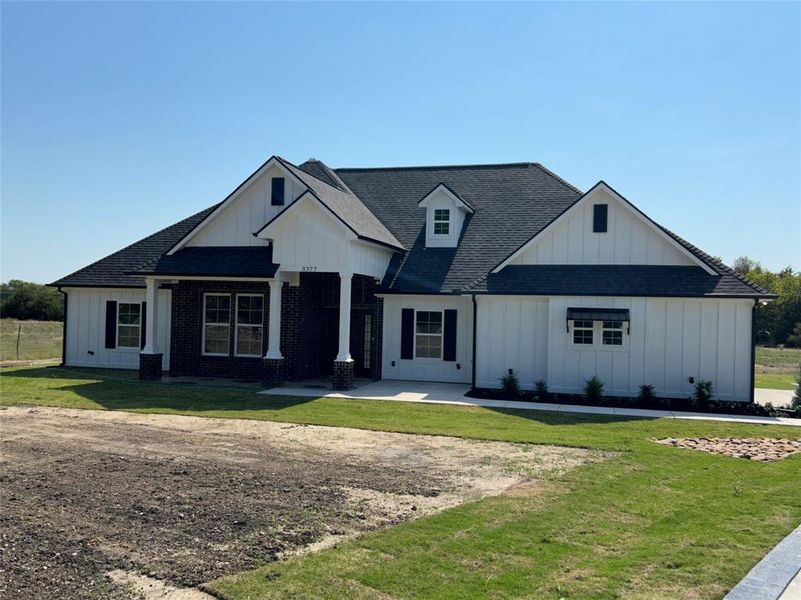 Modern inspired farmhouse with a front yard