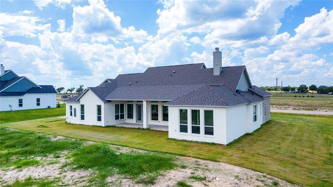 Rear view of house with a patio area and a yard